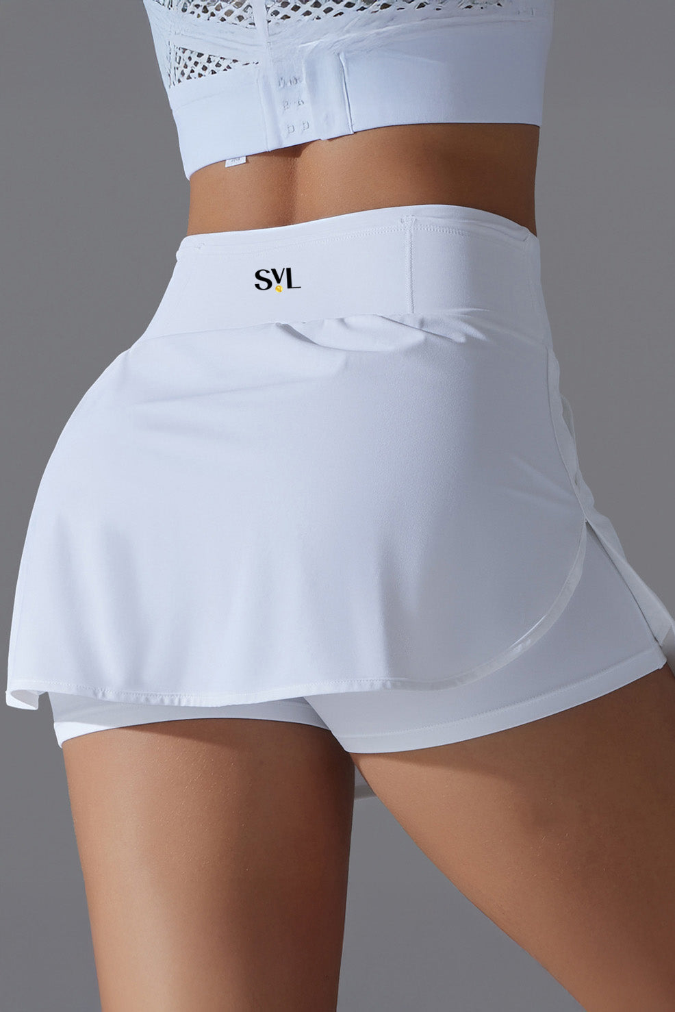 SVL Padel Ace & Allure Skirt in white, featuring a flared design with built-in shorts and 2 pockets, perfect for dynamic movements on the padel court