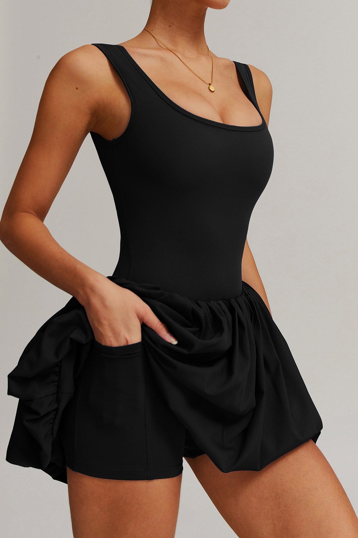 SVL Padel Bubble Belle Dress in black, designed with a playful bubble hem, moisture-wicking fabric, and built-in shorts for stylish performance during padel matches