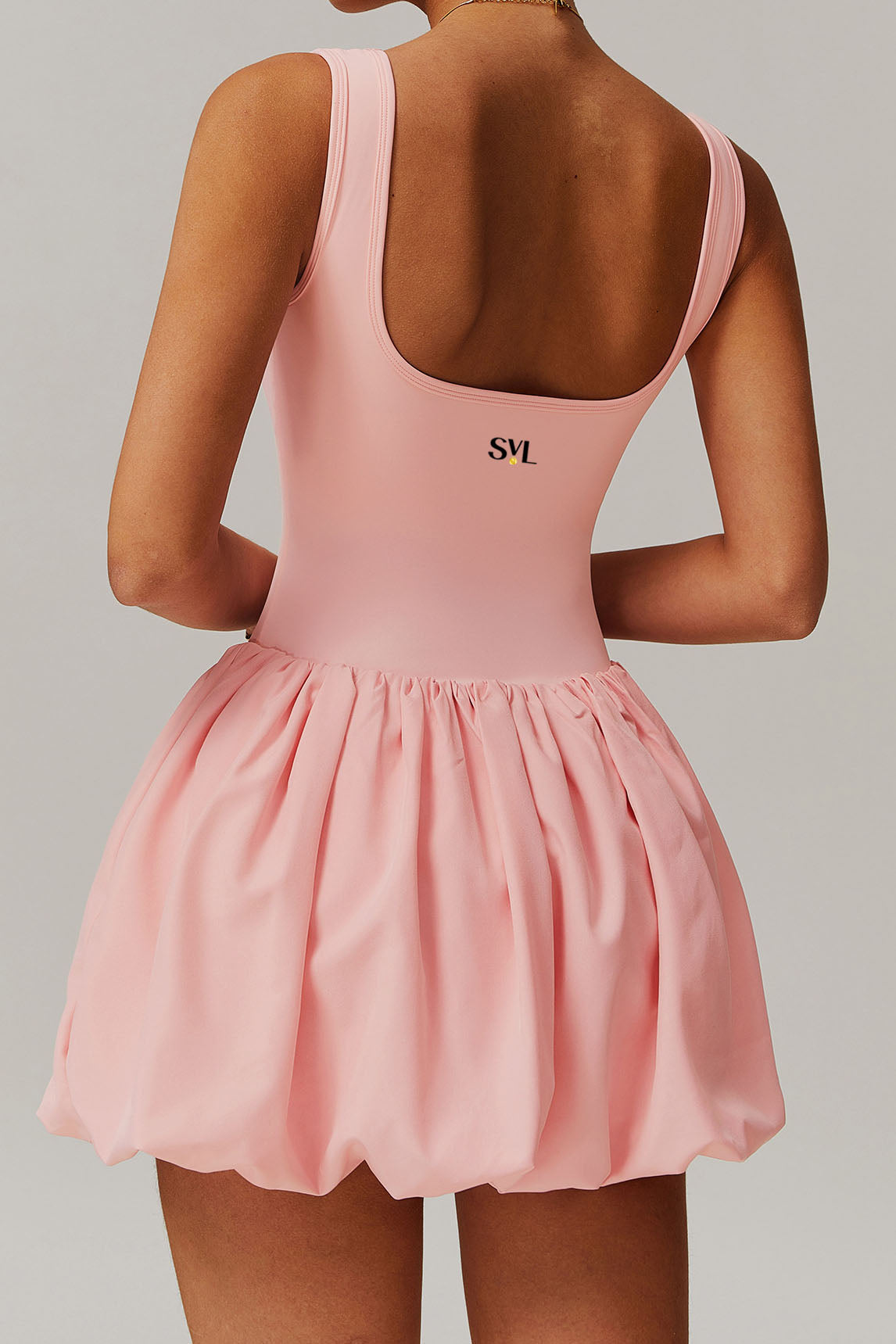 SVL Padel Bubble Belle Dress in pink, designed with a playful bubble hem, moisture-wicking fabric, and built-in shorts for stylish performance during padel matches