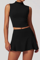 SVL Padel Swan Sway Set in Black – a graceful and performance-focused ensemble featuring a sleeveless, high-neck top paired with a flared skirt with built-in shorts. Designed for elegance, comfort, and agility, this set is crafted from lightweight, breathable fabric with an elastic waistband, ensuring effortless movement and style on the padel court