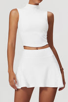 SVL Padel Swan Sway Set in White – a graceful and performance-focused ensemble featuring a sleeveless, high-neck top paired with a flared skirt with built-in shorts. Designed for elegance, comfort, and agility, this set is crafted from lightweight, breathable fabric with an elastic waistband, ensuring effortless movement and style on the padel court