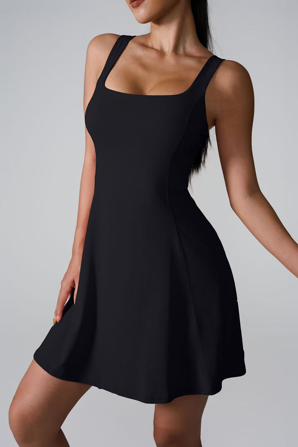 SVL Padel Sweet Swirl Dress in black, showcasing a swirling pattern, comfortable fit, and built-in shorts, perfect for both padel games and casual outings