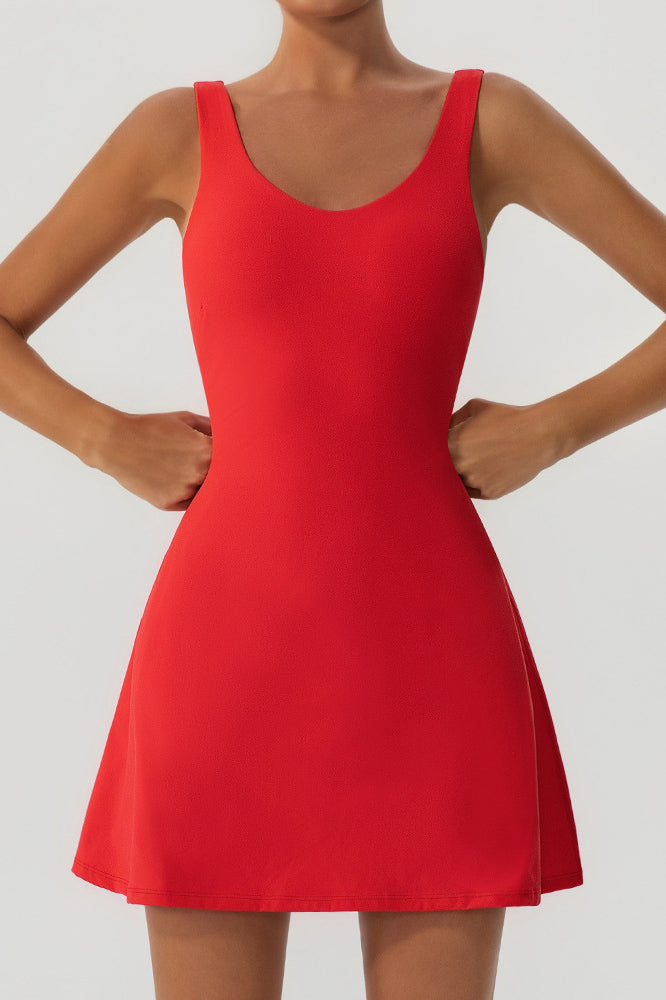 Close-up front view of the red Alisa padel and tennis dress highlighting the fitted bodice, scoop neckline, and flared skirt.