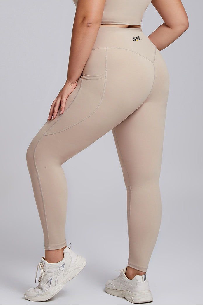 Back view of SVL beige leggings Active Aura high waisted plus size performance leggings with pocket for padel and tennis