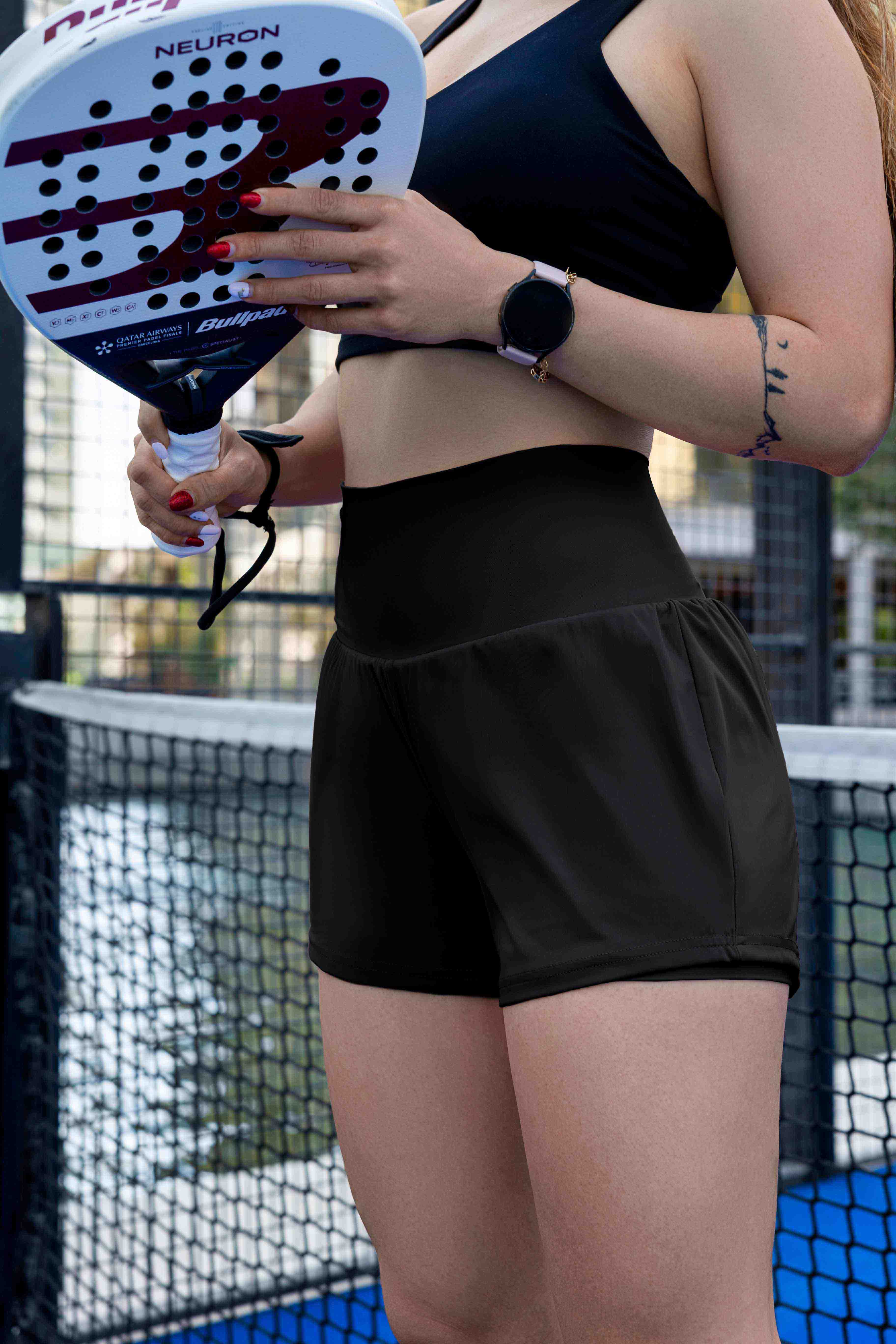 Female padel player wearing SVL black shorts Cloud Comfort during a padel and tennis match