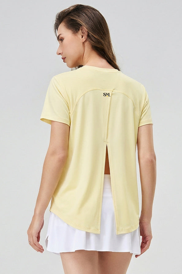 Back view of SVL Clara T-shirt in yellow designed for padel and tennis players