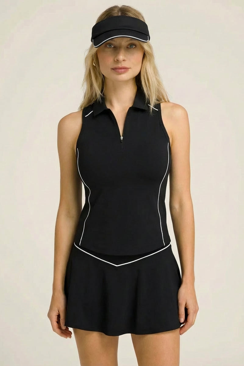 A female padel and tennis player wearing the black SVL Kate skirt set with a matching visor.