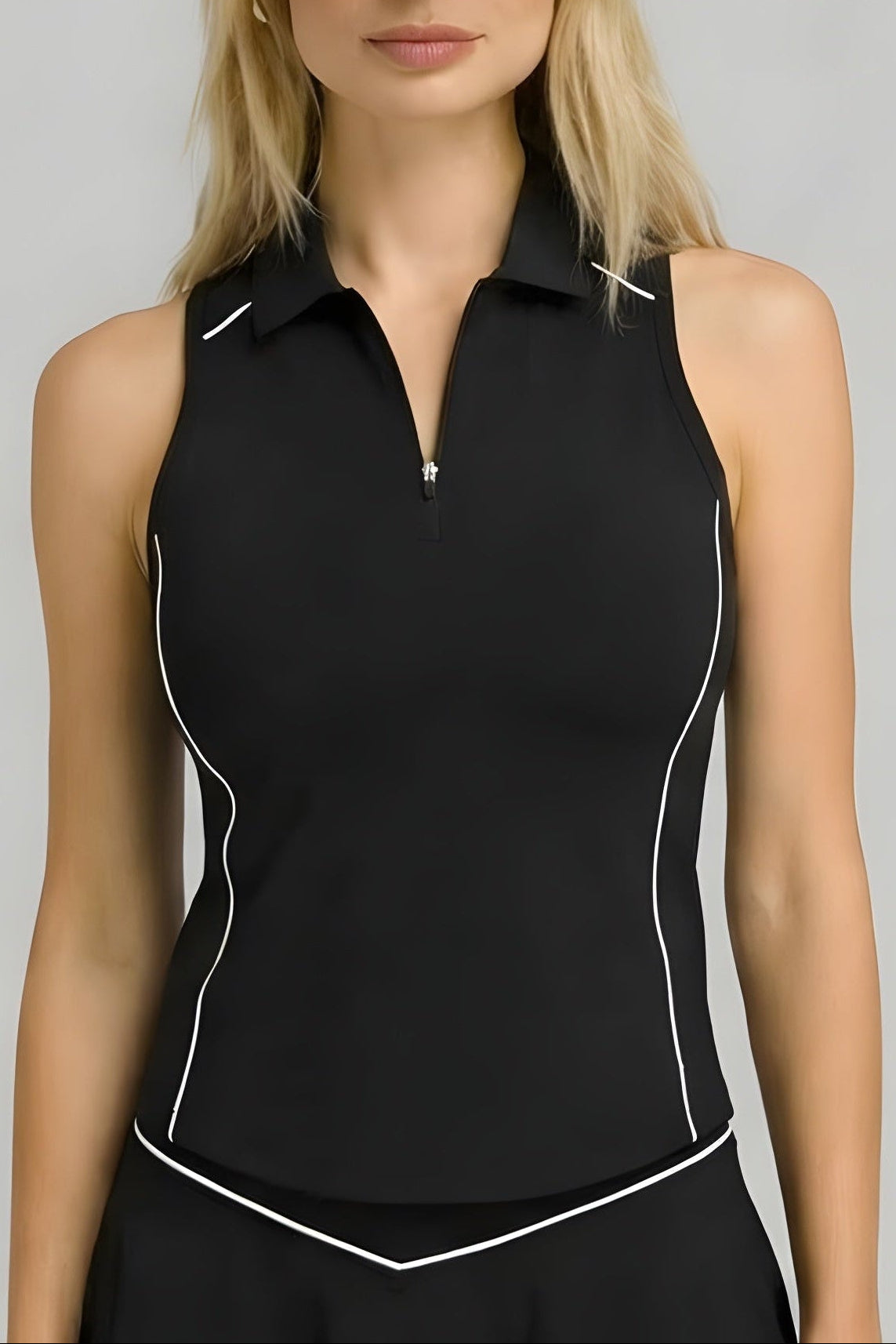 Front studio shot of the black SVL Kate performance tennis and padel top, featuring a sleeveless zip-up polo design with white piping details.