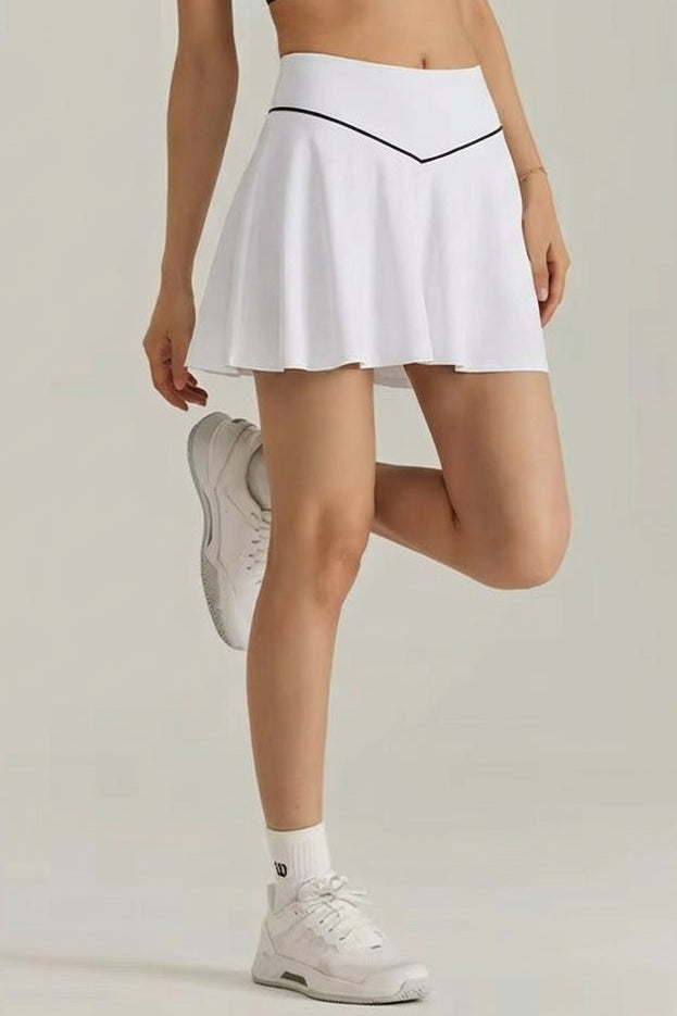 Side profile view of the white SVL Kate padel skirt featuring a clean athletic silhouette and integrated under-shorts.