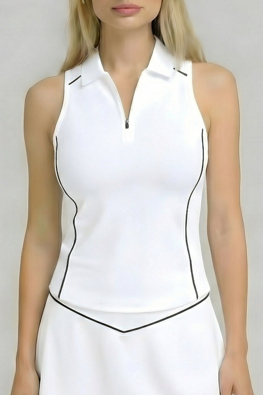 Front studio view of the white SVL Kate performance tennis and padel top, featuring a sleeveless design with a zip-up polo collar and black piping accents.