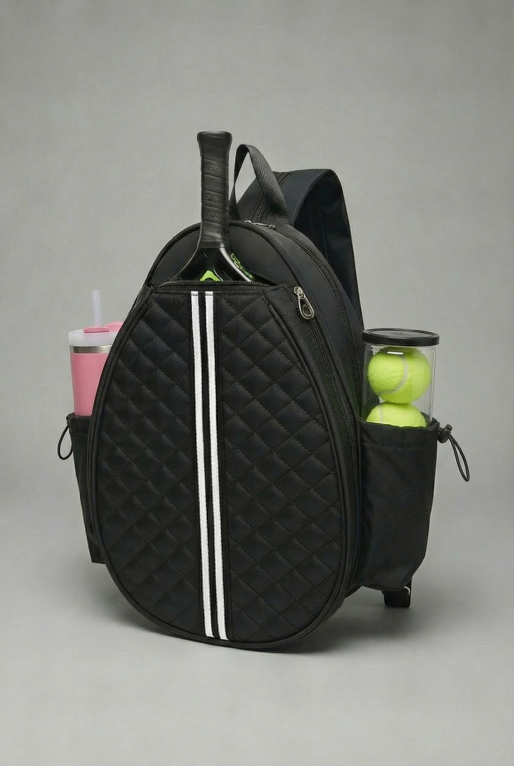 Premium black quilted SVL padel backpack featuring a dedicated racket compartment, side pockets for gear, and sophisticated athletic styling.