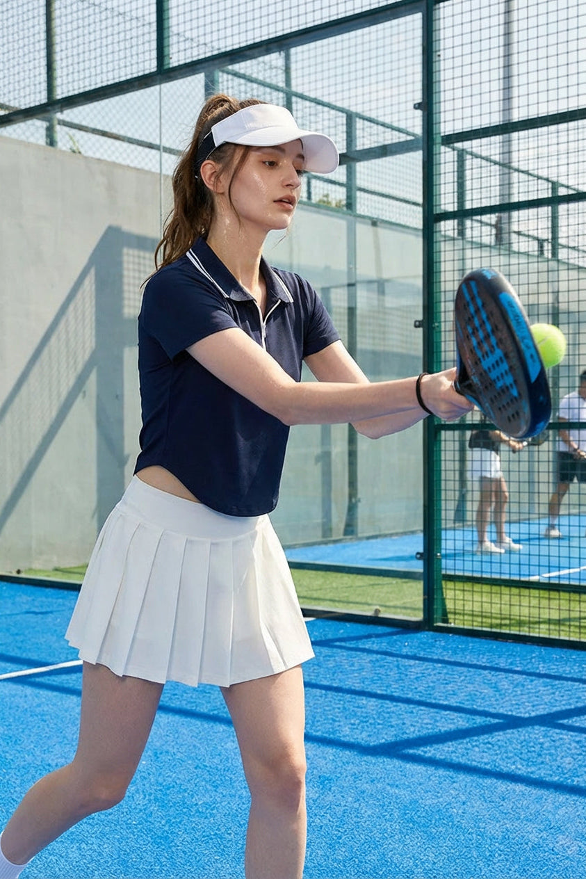 Female padel player wearing SVL navy polo t-shirt Perfect Polo during a padel and tennis match
