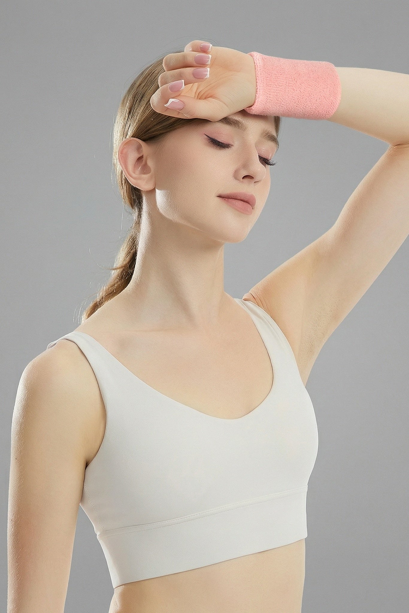 Female padel player using SVL pink sweat wristband for padel and tennis performance