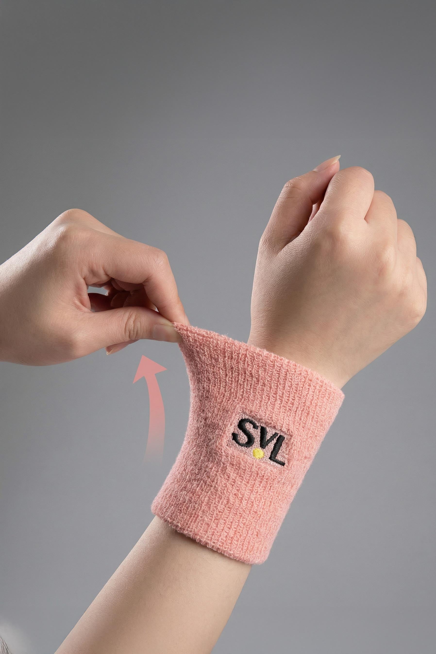 Close-up of SVL pink padel and tennis wristband showing stretch and absorbent fabric