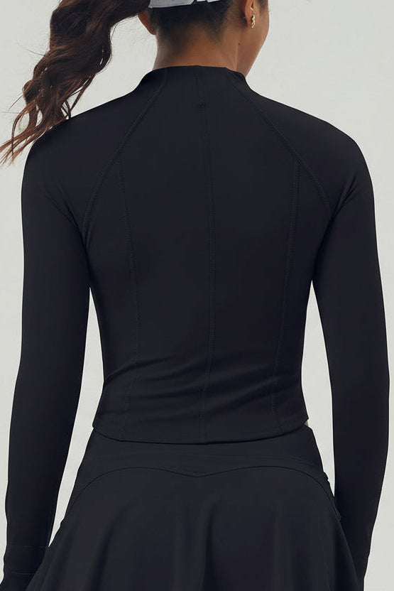 Rear view of the black Swan Sway performance jacket showing the contoured seams and aerodynamic fit for on-court movement.