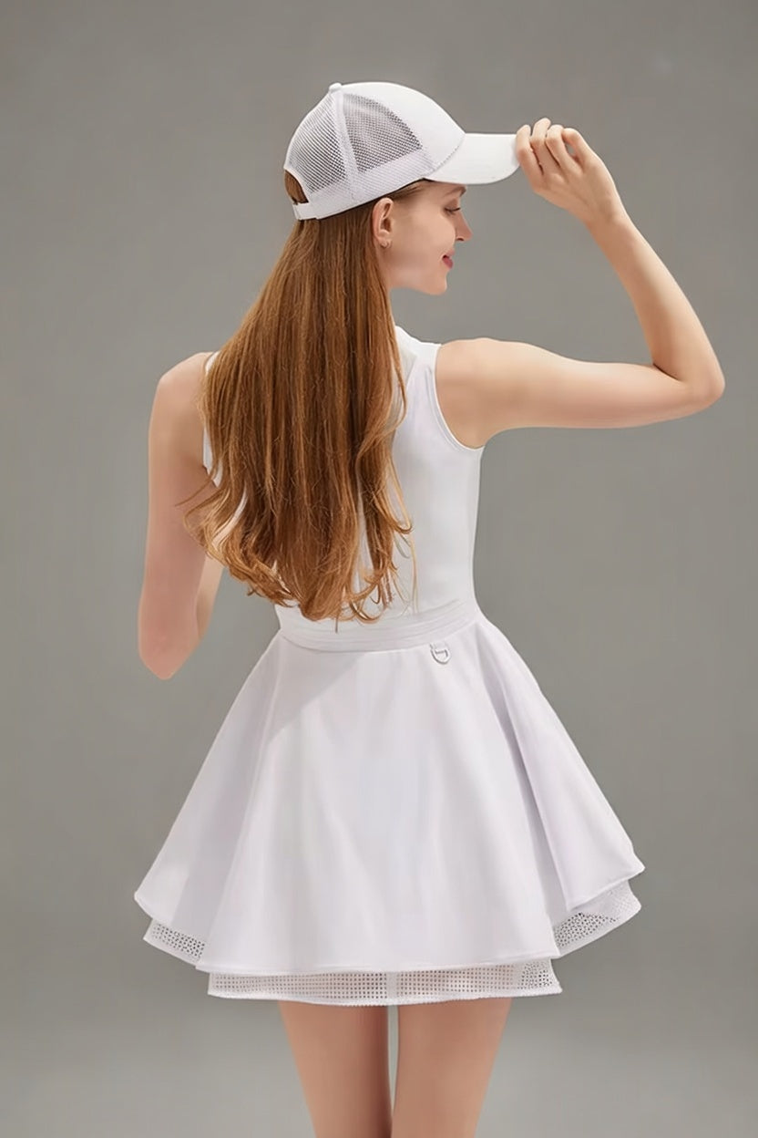 Rear view of the white Wiktoria performance dress showing the elegant sleeveless design and the volume of the pleated, mesh-lined skirt.