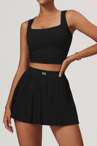 SVL Padel Plush Pleat Set in Black – a stylish and performance-driven outfit featuring a pleated skirt with built-in shorts and a matching top with a squared neckline. Crafted from lightweight, soft-touch fabric, this set ensures breathability, comfort, and unrestricted movement, making it the perfect choice for padel players who want to play in style.