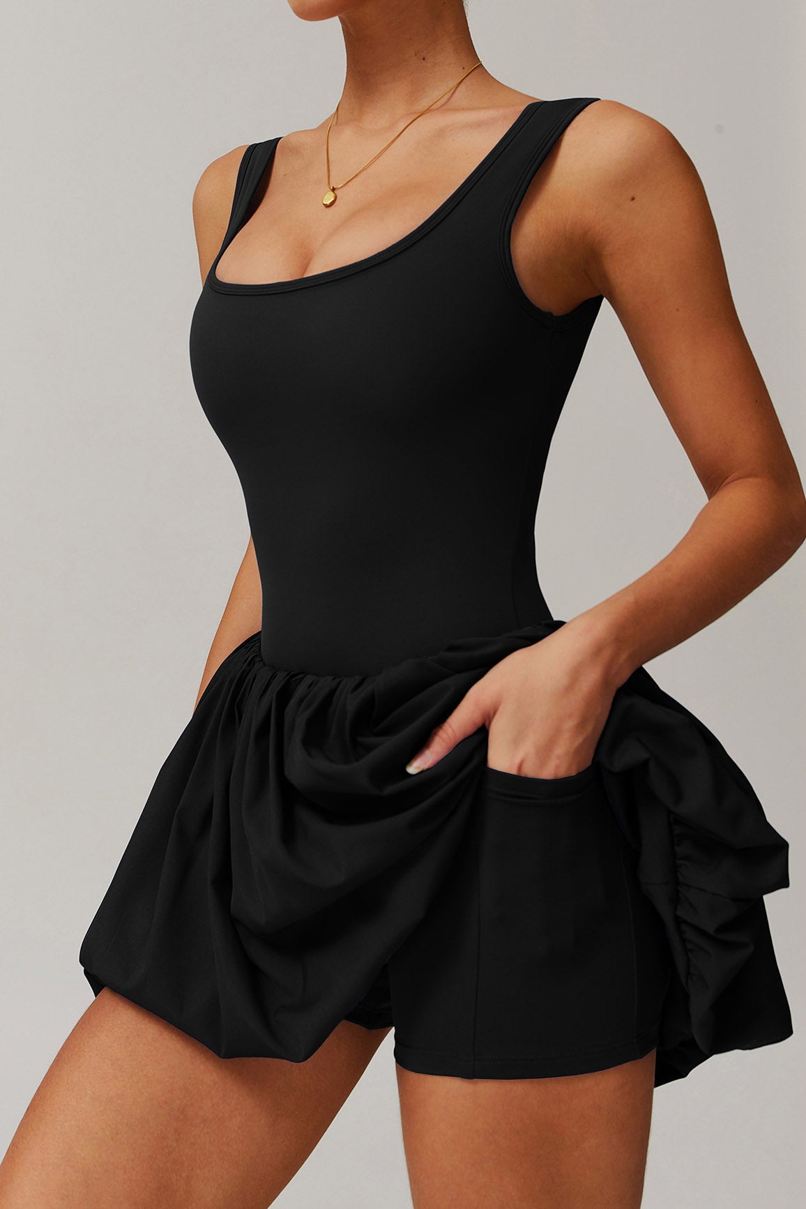 SVL Padel Bubble Belle Dress in black, designed with a playful bubble hem, moisture-wicking fabric, and built-in shorts for stylish performance during padel matches