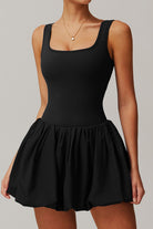 SVL Padel Bubble Belle Dress in black, designed with a playful bubble hem, moisture-wicking fabric, and built-in shorts for stylish performance during padel matches