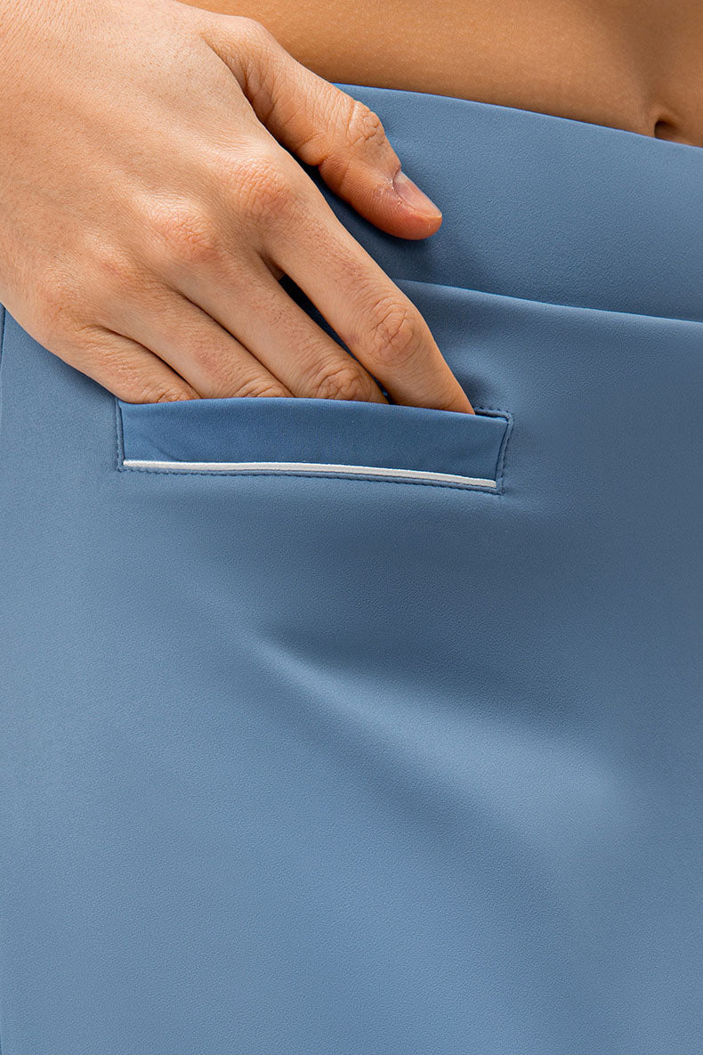 SVL Padel Court & Confidence Skirt in serene blue, designed with a streamlined fit, built-in shorts, and stretch fabric, ensuring confidence and freedom of movement on the padel court
