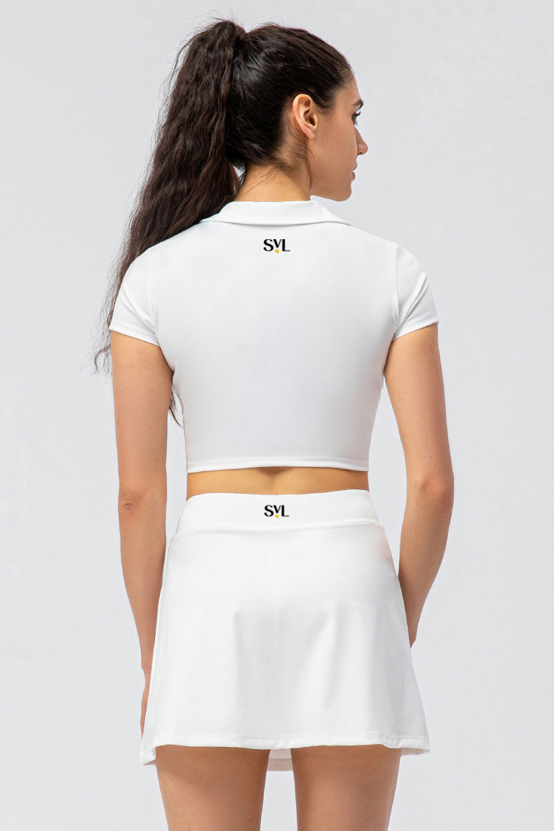 SVL Padel Court & Confidence Set in White – a sleek and performance-driven ensemble featuring a fitted, moisture-wicking top paired with a streamlined skirt with built-in shorts. Designed for competitive padel play, this set offers a perfect blend of comfort, style, and stretch fabric to ensure confidence and freedom of movement on the court
