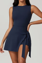 SVL Padel Play & Party Dress in dark blue, featuring a chic wrap-tie detail, flattering silhouette, and built-in shorts for versatile wear on and off the padel court
