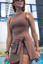 SVL Padel Play & Party Dress in mocha brown, featuring a chic wrap-tie detail, flattering silhouette, and built-in shorts for versatile wear on and off the padel court
