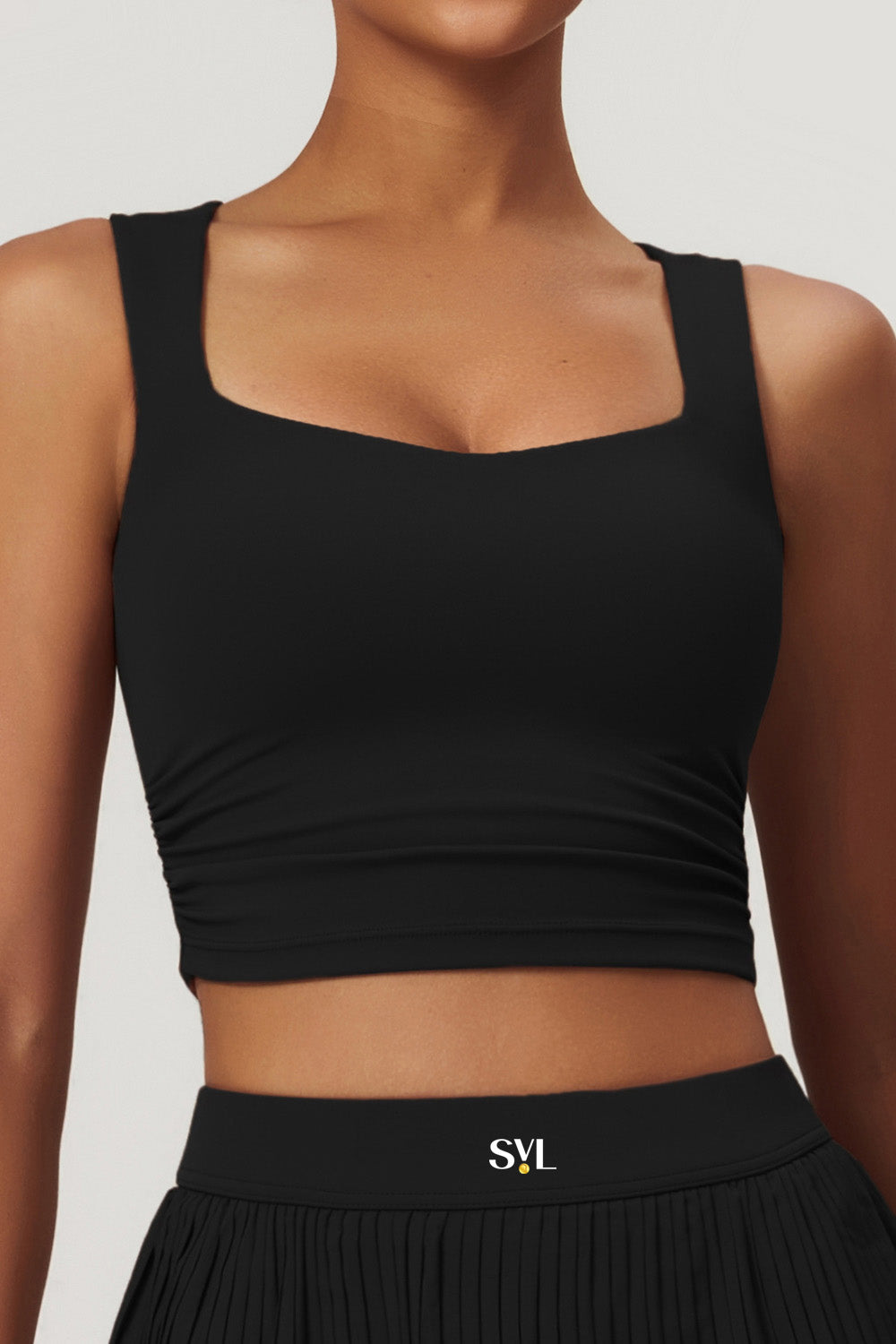 SVL Padel Plush Pleat Set in Black – a stylish and performance-driven outfit featuring a pleated skirt with built-in shorts and a matching top with a squared neckline. Crafted from lightweight, soft-touch fabric, this set ensures breathability, comfort, and unrestricted movement, making it the perfect choice for padel players who want to play in style.