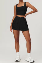 SVL Padel Plush Pleat Set in Black – a stylish and performance-driven outfit featuring a pleated skirt with built-in shorts and a matching top with a squared neckline. Crafted from lightweight, soft-touch fabric, this set ensures breathability, comfort, and unrestricted movement, making it the perfect choice for padel players who want to play in style.