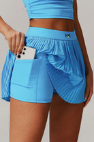 SVL Padel Plush Pleat Set in Cyan Blue – a stylish and performance-driven outfit featuring a pleated skirt with built-in shorts and a matching top with a squared neckline. Crafted from lightweight, soft-touch fabric, this set ensures breathability, comfort, and unrestricted movement, making it the perfect choice for padel players who want to play in style.