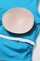 SVL Padel Plush Pleat Set in Cyan Blue – a stylish and performance-driven outfit featuring a pleated skirt with built-in shorts and a matching top with a squared neckline. Crafted from lightweight, soft-touch fabric, this set ensures breathability, comfort, and unrestricted movement, making it the perfect choice for padel players who want to play in style.