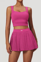 SVL Padel Plush Pleat Set in Magenta – a stylish and performance-driven outfit featuring a pleated skirt with built-in shorts and a matching top with a squared neckline. Crafted from lightweight, soft-touch fabric, this set ensures breathability, comfort, and unrestricted movement, making it the perfect choice for padel players who want to play in style.