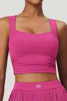SVL Padel Plush Pleat Set in Magenta – a stylish and performance-driven outfit featuring a pleated skirt with built-in shorts and a matching top with a squared neckline. Crafted from lightweight, soft-touch fabric, this set ensures breathability, comfort, and unrestricted movement, making it the perfect choice for padel players who want to play in style.