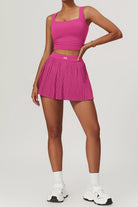 SVL Padel Plush Pleat Set in Magenta – a stylish and performance-driven outfit featuring a pleated skirt with built-in shorts and a matching top with a squared neckline. Crafted from lightweight, soft-touch fabric, this set ensures breathability, comfort, and unrestricted movement, making it the perfect choice for padel players who want to play in style.