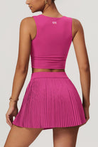 SVL Padel Plush Pleat Set in Magenta – a stylish and performance-driven outfit featuring a pleated skirt with built-in shorts and a matching top with a squared neckline. Crafted from lightweight, soft-touch fabric, this set ensures breathability, comfort, and unrestricted movement, making it the perfect choice for padel players who want to play in style.