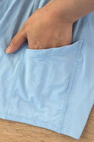 Close-up detail of the sky blue Alisa dress showcasing the integrated side pocket in the under-shorts for convenient padel ball storage.