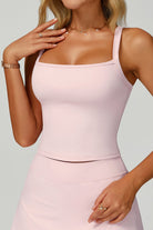 Close-up studio view of the pink SVL Anna padel and tennis top featuring a modern square neckline and supportive wide straps.