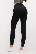 Rear view of the black Arwa sweatpants showing the SVL brand logo on the back waistband and the flattering, athletic design.