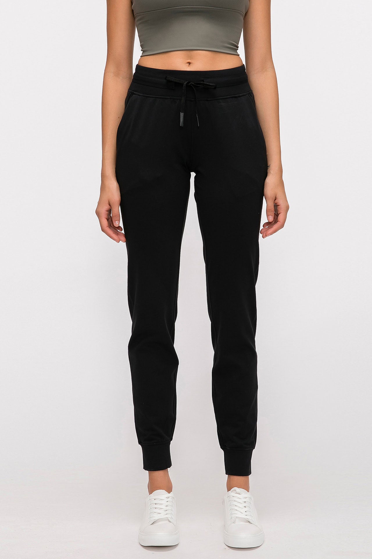 Front-facing studio shot of the black Arwa sweatpants featuring a comfortable high-waisted drawstring and tapered athletic fit.