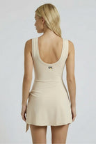 Back view of SVL cream beige padel and tennis dress Play and Party athletic performance dress for women