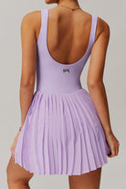 Rear view of the lavender Daria pleated tennis and padel dress featuring the SVL brand logo and a supportive scoop back.
