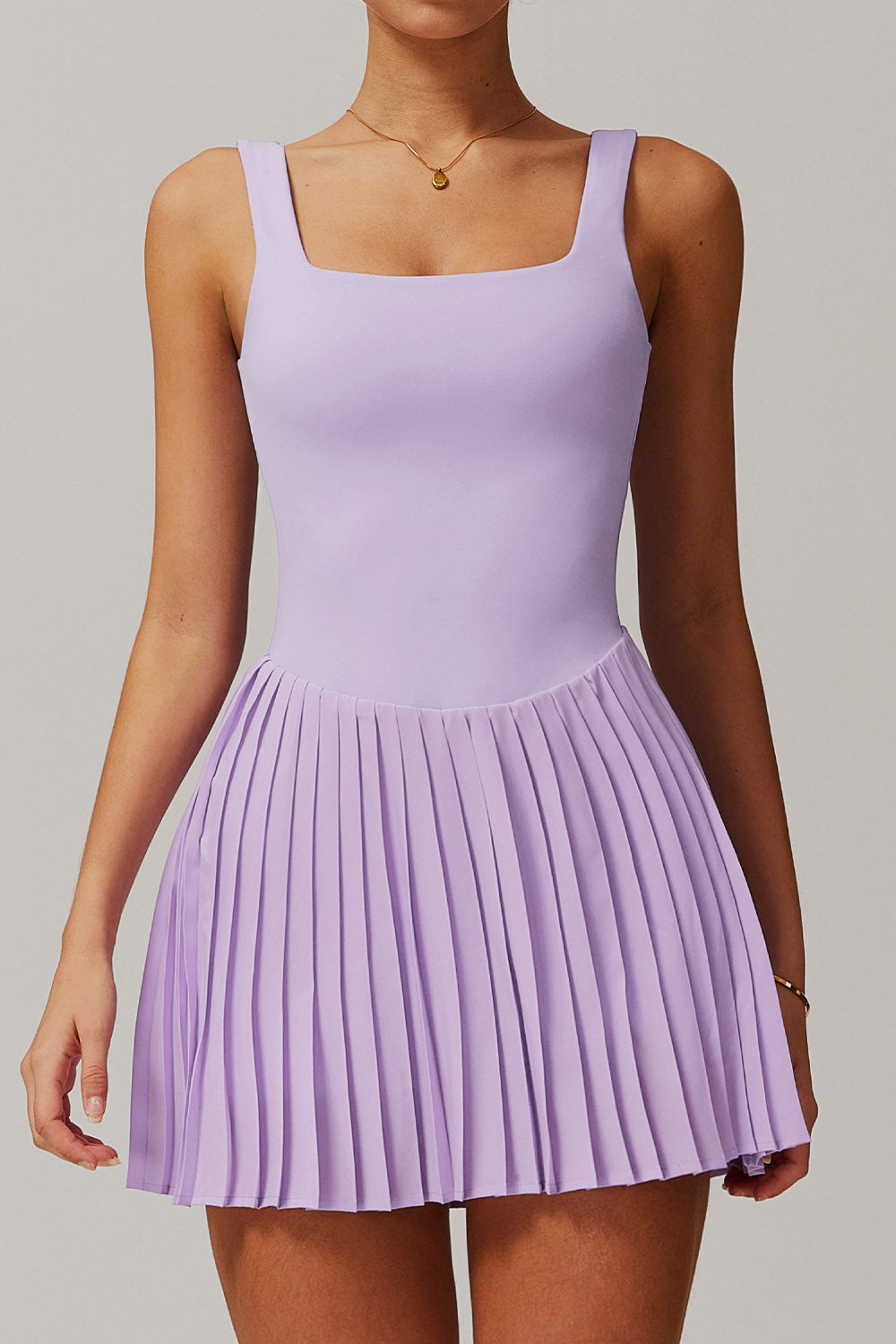 Front view of the lavender Daria performance tennis and padel dress with a square neckline and elegant pleated skirt.