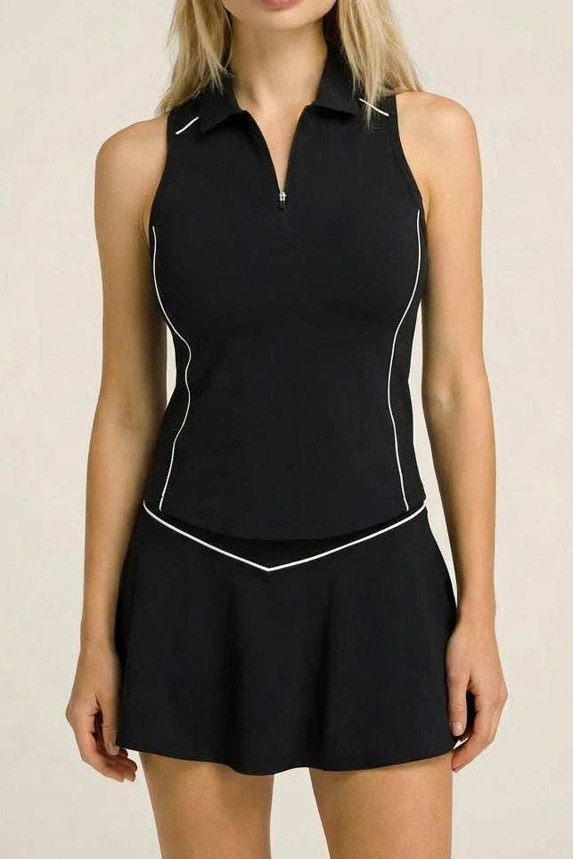A female padel and tennis player wearing the black SVL Kate skirt set with a matching visor.