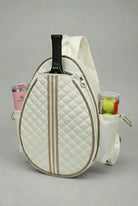 A premium white quilted SVL padel backpack featuring a dedicated racket compartment, side mesh pockets for a water bottle and padel balls, and adjustable straps.