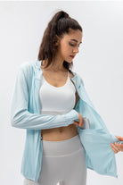 Detail view of the ice blue SVL Maya performance jacket showing an internal pocket designed to hold a mobile phone during exercise.