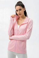 Front view of the SVL Maya Jacket in pink, a lightweight SPF 50 performance tunic with long sleeves and side pockets for women.