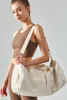 SVL cream padel and tennis duffle bag worn over the shoulder for gym and match days