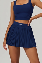 Woman padel player wearing SVL Plush Pleat Navy Blue Padel Set