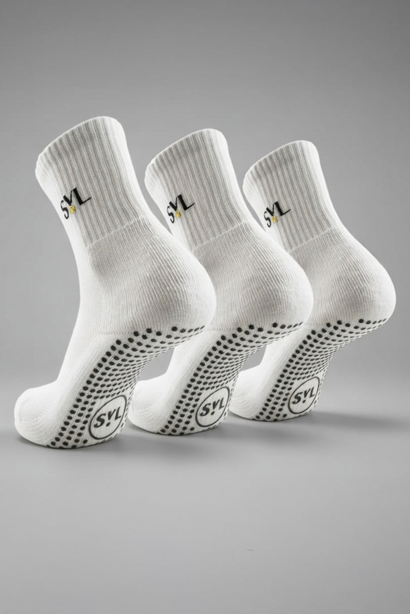 Close-up of three white SVL premium padel grip socks featuring non-slip soles and embroidered brand logo for high-performance court stability.