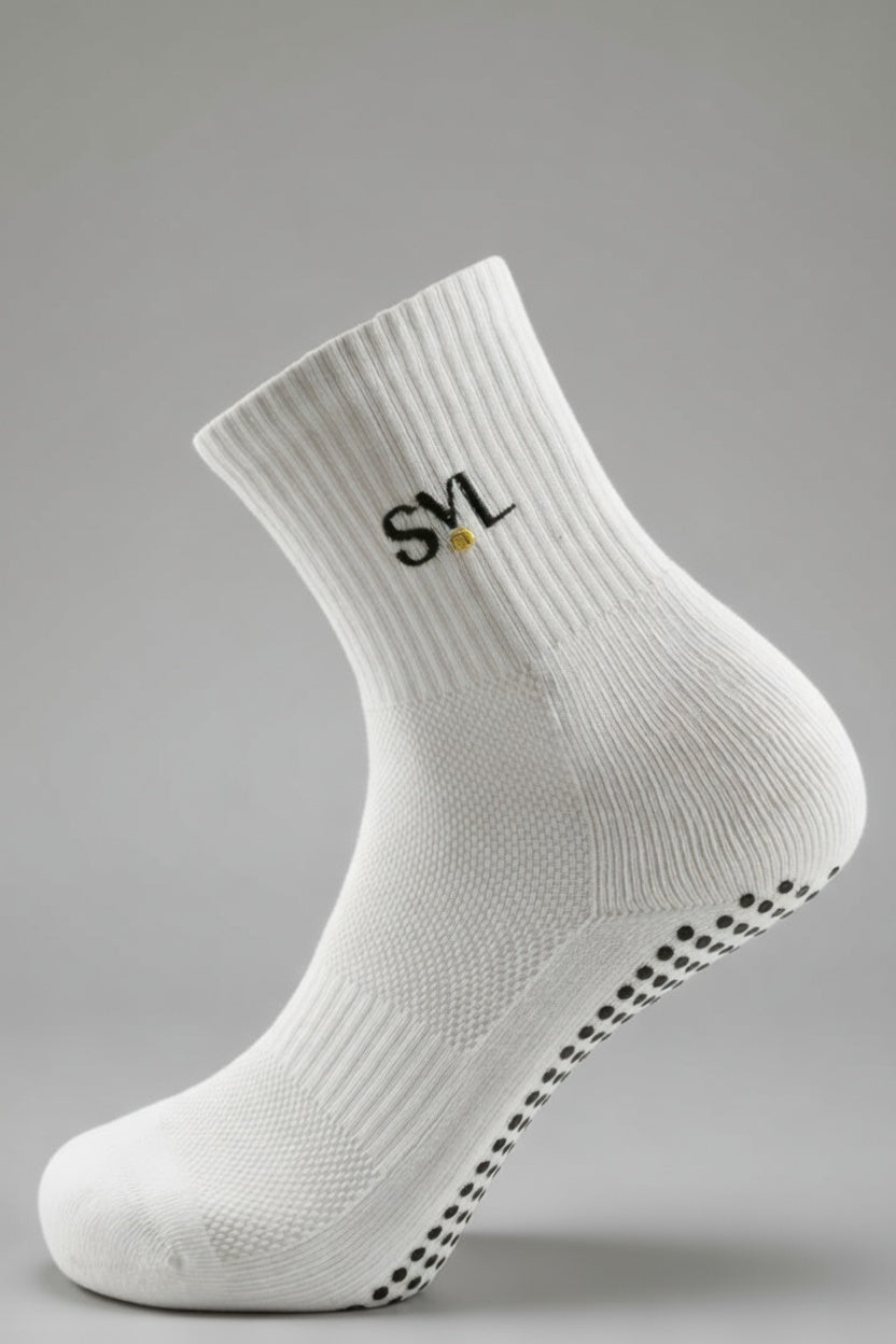 Close-up of white SVL premium padel grip socks featuring non-slip soles and embroidered brand logo for high-performance court stability.